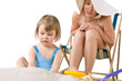 © CandyBox Images - Mother with child playing with beach toys