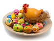 Lots of easter eggs and hen in nest on wooden plate