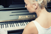Portrait Of Woman Playing On The Retro Style Piano