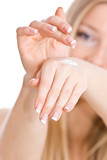 Fototapeta  - Causasian blonde woman creaming hands and palms nails