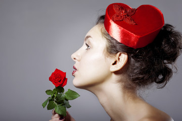 Wall Mural - glamorous girl in an elegant hat in the form of heart