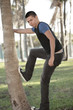 Man posing by a tree in the park