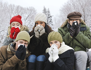 Group of friends with colds outside in winter