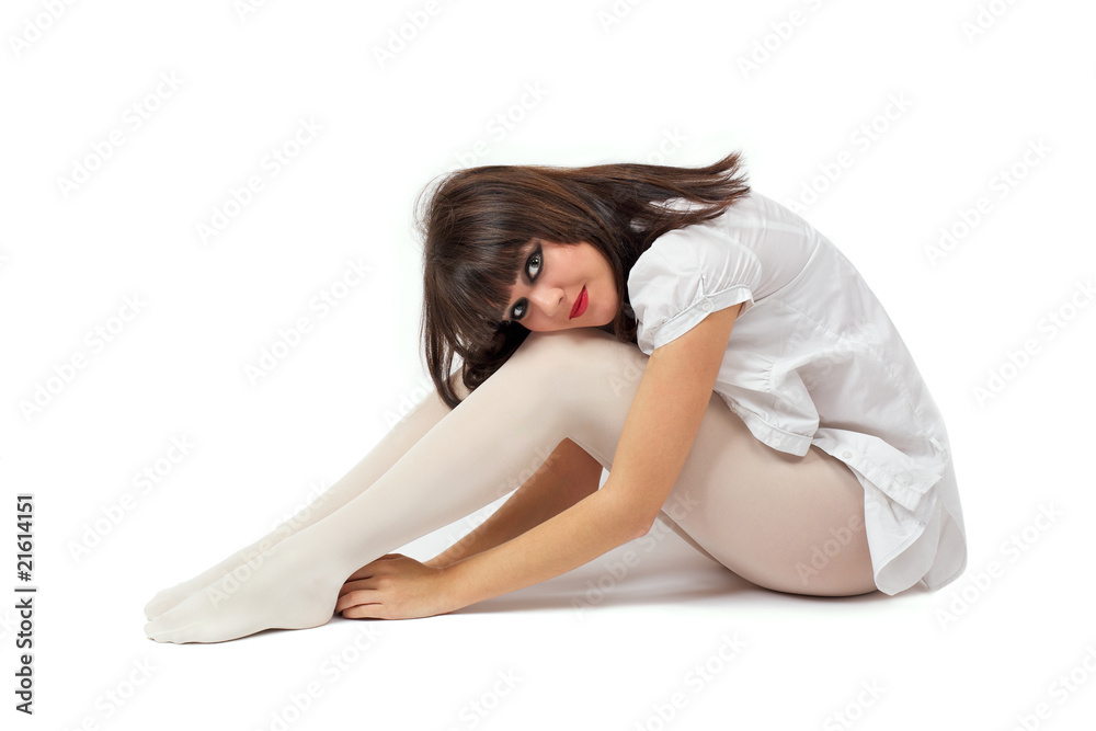 Young beautiful women in white pantyhose sits on a white Adobe Stock
