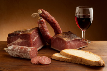 Wall Mural - mix of parma prosciutto and salami with bread glass of wine