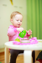 Wall Mural - Little girl playing with toys