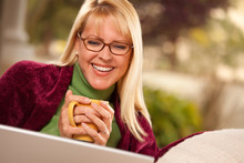 Beautiful Woman Enjoys Her Warm Drink And Laptop