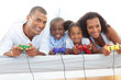 © WavebreakMediaMicro - Animated family playing video game lying down on bed