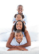 © WavebreakMediaMicro - Animated family having fun lying down on bed