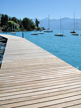 Wooden Pier Against Lake Thun And Alps. Switzerland
