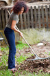 © Xalanx - Redhead woman using a rake for cleaning