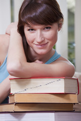 woman with pile of books