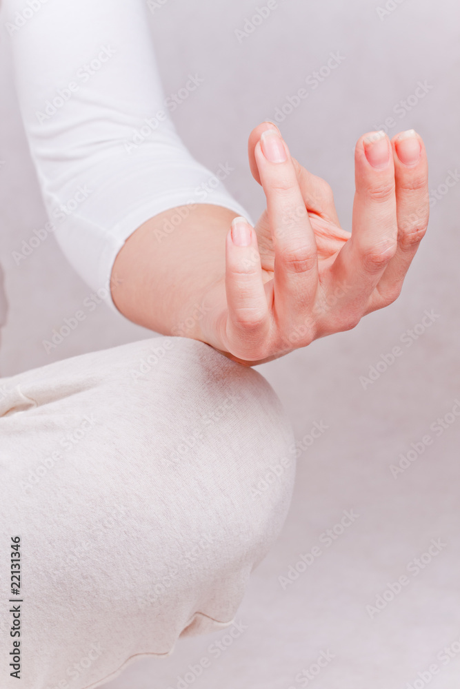 One hand of meditating woman in lotos pose - obrazy, fototapety, plakaty 