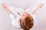 Fototapeta  - young woman relaxing (up view) - on white background