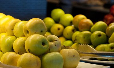 Yellow and Green Apples on a Fruit Bar