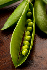 Wall Mural - open pod with peas on wood table