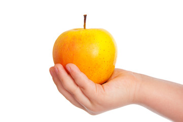 Children's hand with an apple on the white