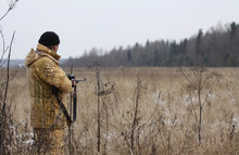 Huner With Rifle Waiting For Animal