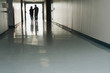 © Paul Burns/Blend Images - Two people standing at end of corridor in hospital