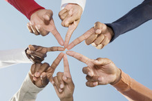 Multi-ethnic Friends Pointing Fingers In Circle
