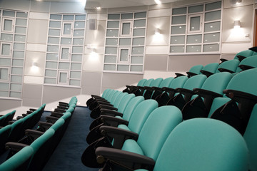 interior of hall for conferences. rows of chairs for spectators.