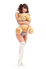 young woman embraces teddy bear
