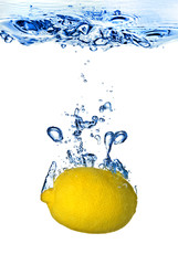 Wall Mural - fresh lemon dropped into water with bubbles isolated on white