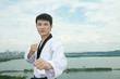© zhu difeng - one asian man playing with taekwondo outdoor