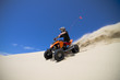Big sand spray from ATV quadbike rider in the dunes