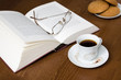 Cup of coffee, old book,  glasses & biscuits, soft focus