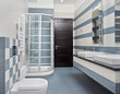 Modern bathroom in blue and gray tones with shower cubicle