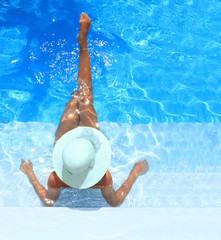 Wall Mural - woman enjoying a swimming pool