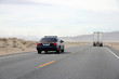 © BigChen - Police car patrol on high way cross desert.