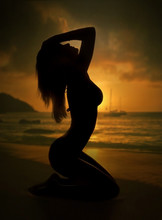 Sexy Woman Silhouette And Sunset Beach
