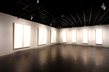 empty frames in a room against a white wall .