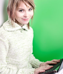 pretty young college student working on her laptop computer in f