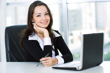 Smiling friendly business woman, working on laptop