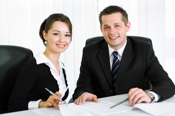 Smart young business people smiling and working in the office