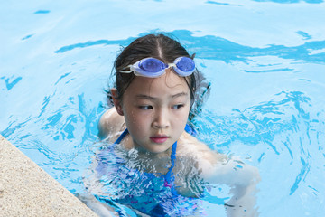 little asian girl in swimming pool