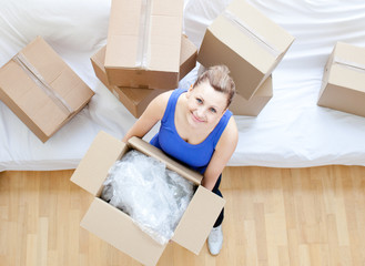 Wall Mural - Delighted woman holding a box