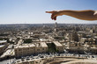 Man pointing to the infinite over the city of Aleppo, Syria