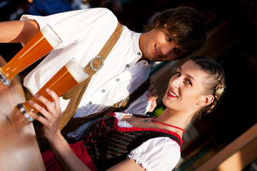 Wall Mural - Couple in Bavarian Tracht drinking wheat beer