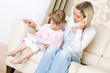 © CandyBox Images - Mother and child - on the phone in living room