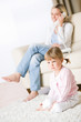 © CandyBox Images - Mother and child in living room watch television