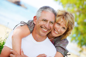 close-up portrait of a mature couple smiling and embracing.