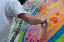 Graffitist Applying Spray Paint