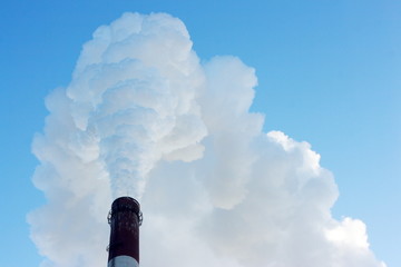 Wall Mural - Smoking stack of thermal power station against a blue sky