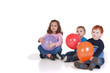 © sdenness - Three kids with balloons at party