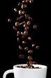 Coffee beans falling in white cup