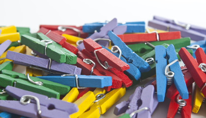 colourful clothes pegs with soft focus on middle red